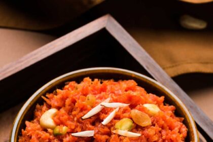 एक कटोरे में परोसा गया गरमागरम गाजर का हलवा, ऊपर से बादाम-काजू से सजाया हुआ, सर्दियों के लिए उपयुक्त पारंपरिक भारतीय मिठाई।