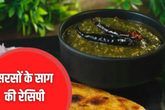 गरमागरम सरसों का साग मक्के की रोटी और देसी घी के साथ परोसा हुआ, सर्दियों की पारंपरिक भारतीय रसोई का दृश्य।