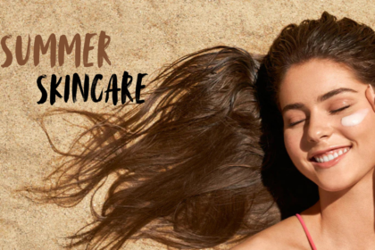 A woman lying on sand with glowing skin, applying sunscreen on her face, representing summer skincare and sun protection. The image highlights healthy, radiant skin during summer with the text “Summer Skincare” displayed.
