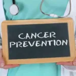 Doctor holding a board with Cancer Prevention message, highlighting the importance of healthy lifestyle choices and early prevention strategies.