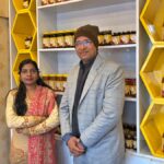 Bihar Honey Girl Anita Kushwaha at her honey store showcasing beekeeping products and honey jars.