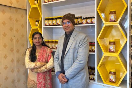 Bihar Honey Girl Anita Kushwaha at her honey store showcasing beekeeping products and honey jars.