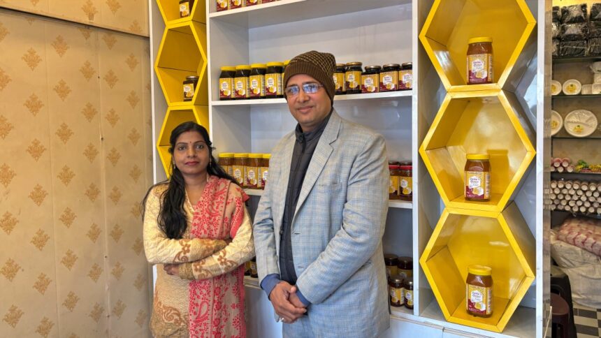 Bihar Honey Girl Anita Kushwaha at her honey store showcasing beekeeping products and honey jars.