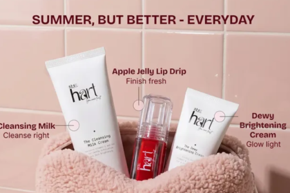 Hart skincare summer essentials kit featuring Cleansing Milk Cream, Apple Jelly Lip Drip, and Dewy Brightening Cream displayed in a soft pink textured pouch against a pastel pink tiled background.