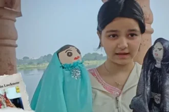 A young student demonstrating handmade cloth puppets as part of an environmental awareness and creative learning project.