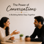 A young man and woman sitting across a table, smiling and having a meaningful conversation in a calm indoor setting