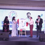 Guests unveil the first edition of Prescription Health Magazine during a grand launch ceremony at Crowne Plaza, Lucknow, as attendees applaud on stage.