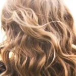 Long, shiny wavy hair highlighting healthy hair care