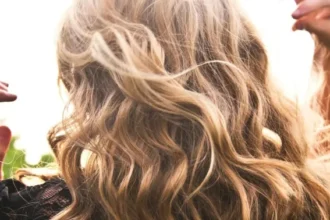 Long, shiny wavy hair highlighting healthy hair care