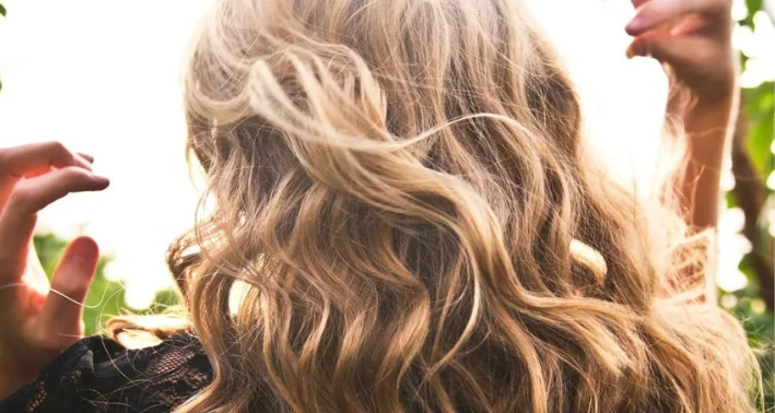 Long, shiny wavy hair highlighting healthy hair care