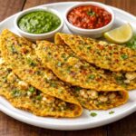 Paneer stuffed moong dal chilla served with green and red chutney