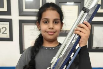 Naira Sharma holding an air rifle after qualifying for the national shooting competition