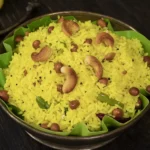 Traditional Indian lemon rice garnished with cashews, peanuts and curry leaves