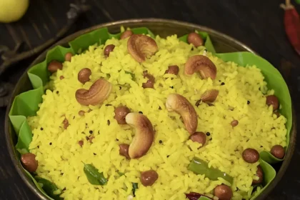 Traditional Indian lemon rice garnished with cashews, peanuts and curry leaves
