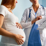 Pregnant woman receiving medical care for anemia prevention and iron deficiency treatment during pregnancy.