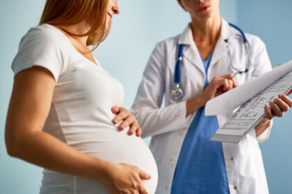 Pregnant woman receiving medical care for anemia prevention and iron deficiency treatment during pregnancy.