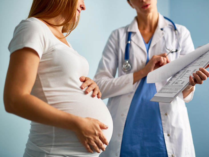 Pregnant woman receiving medical care for anemia prevention and iron deficiency treatment during pregnancy.