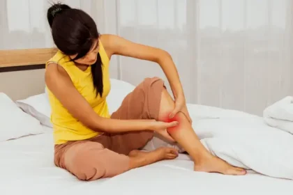 Woman experiencing a painful leg cramp at night