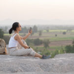 A traveler enjoying a peaceful slow travel experience amid the scenic natural beauty of India.